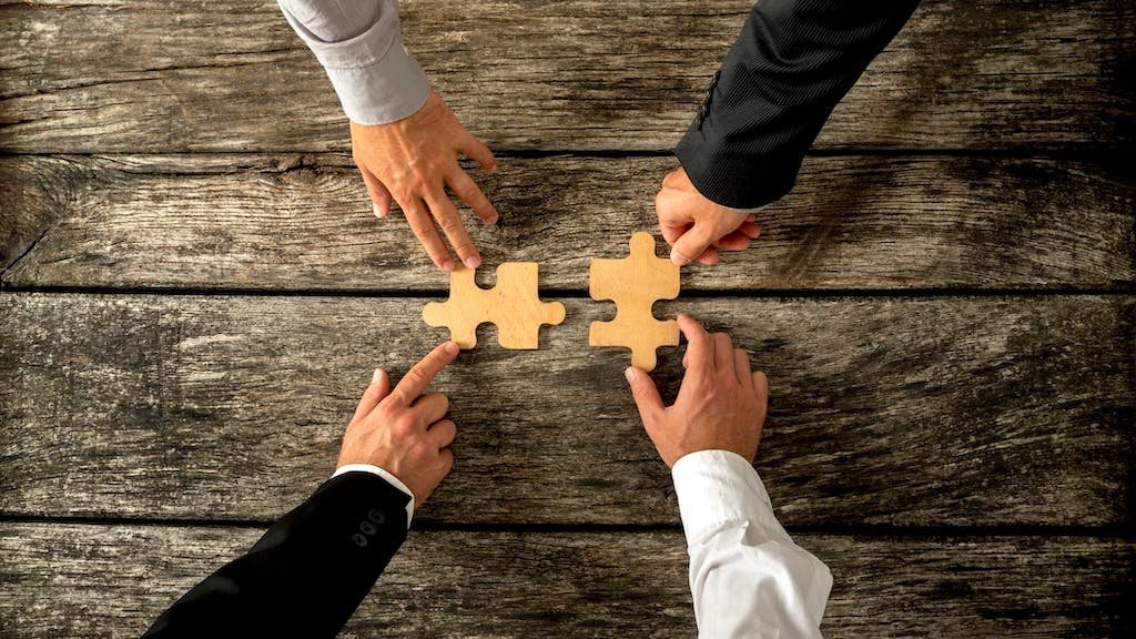 Pushing puzzle pieces together to represent a merger