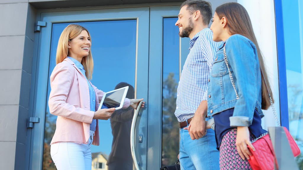 First-time buyers tour a home with a real estate agent