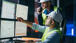 Two engineers work at a computer