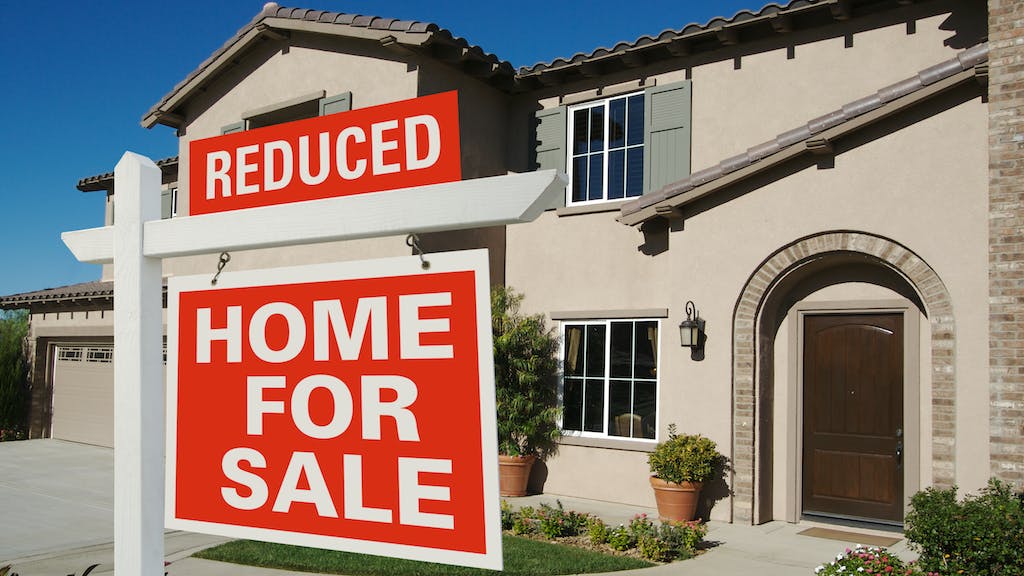 For sale sign in a front yard