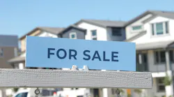 'For Sale' sign in front of a new-home community