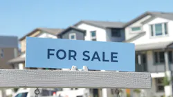 'For Sale' sign in front of a new-home community
