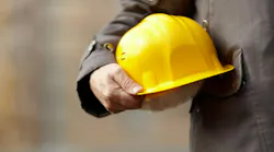 Home builder holding a hard hat