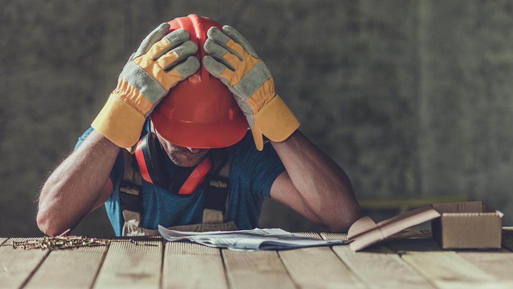 Construction worker looking over house plans