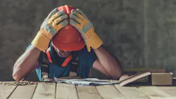 Construction worker looking over house plans
