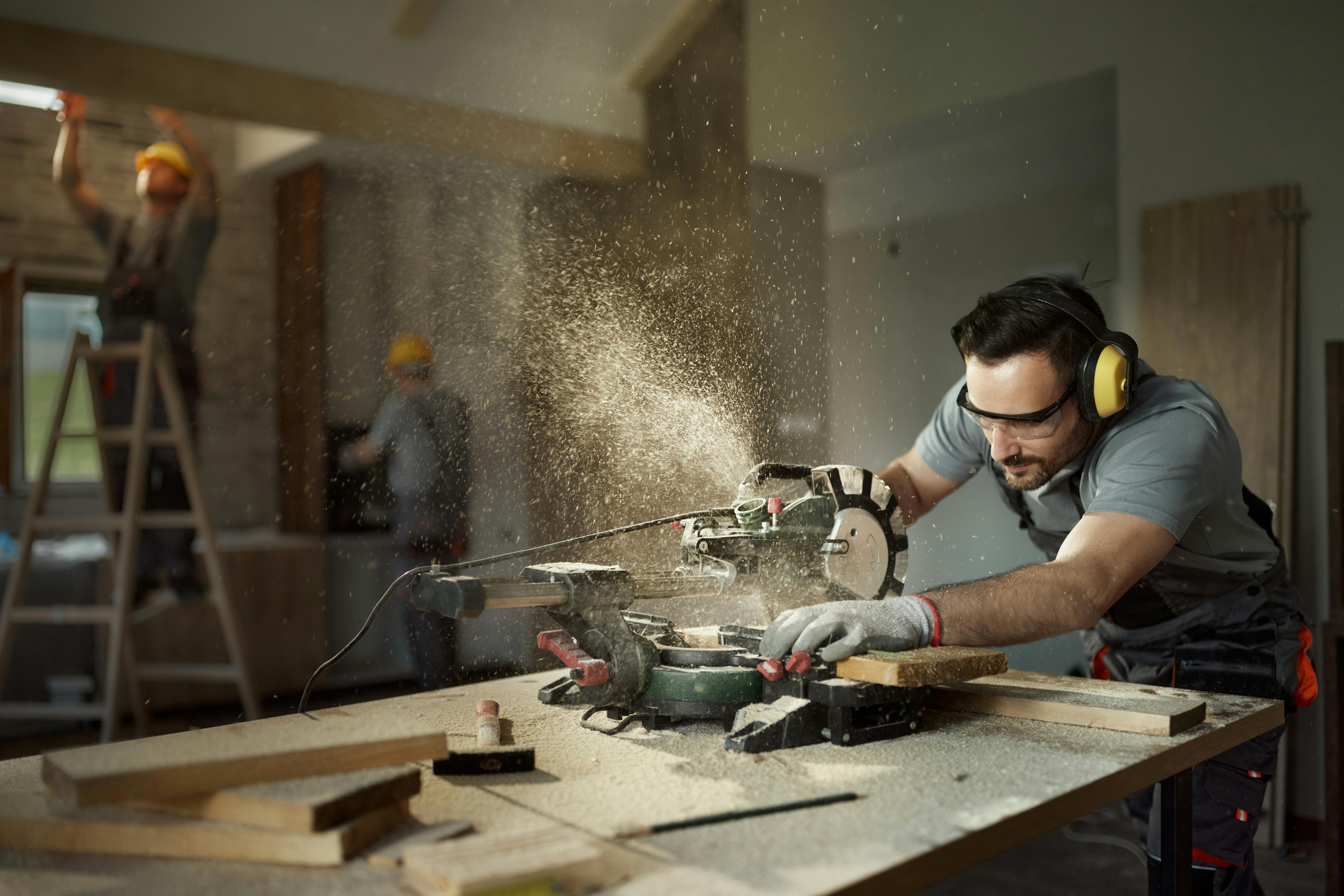 Worker on a mitre saw
