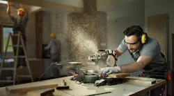 Worker on a mitre saw
