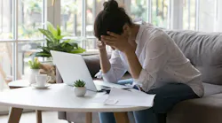 Homeowner looking stressed as she goes over her finances
