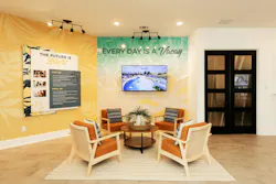 The bright and airy Welcome Center at Sunterra in Florida is focal point of the community’s main model row, and is fitted with multiple screens that display images of events to inspire prospective buyers to picture themselves living and participting in the community.