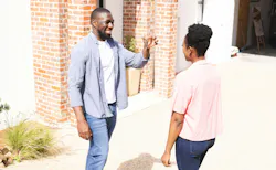 Excited homeowners holding up keys